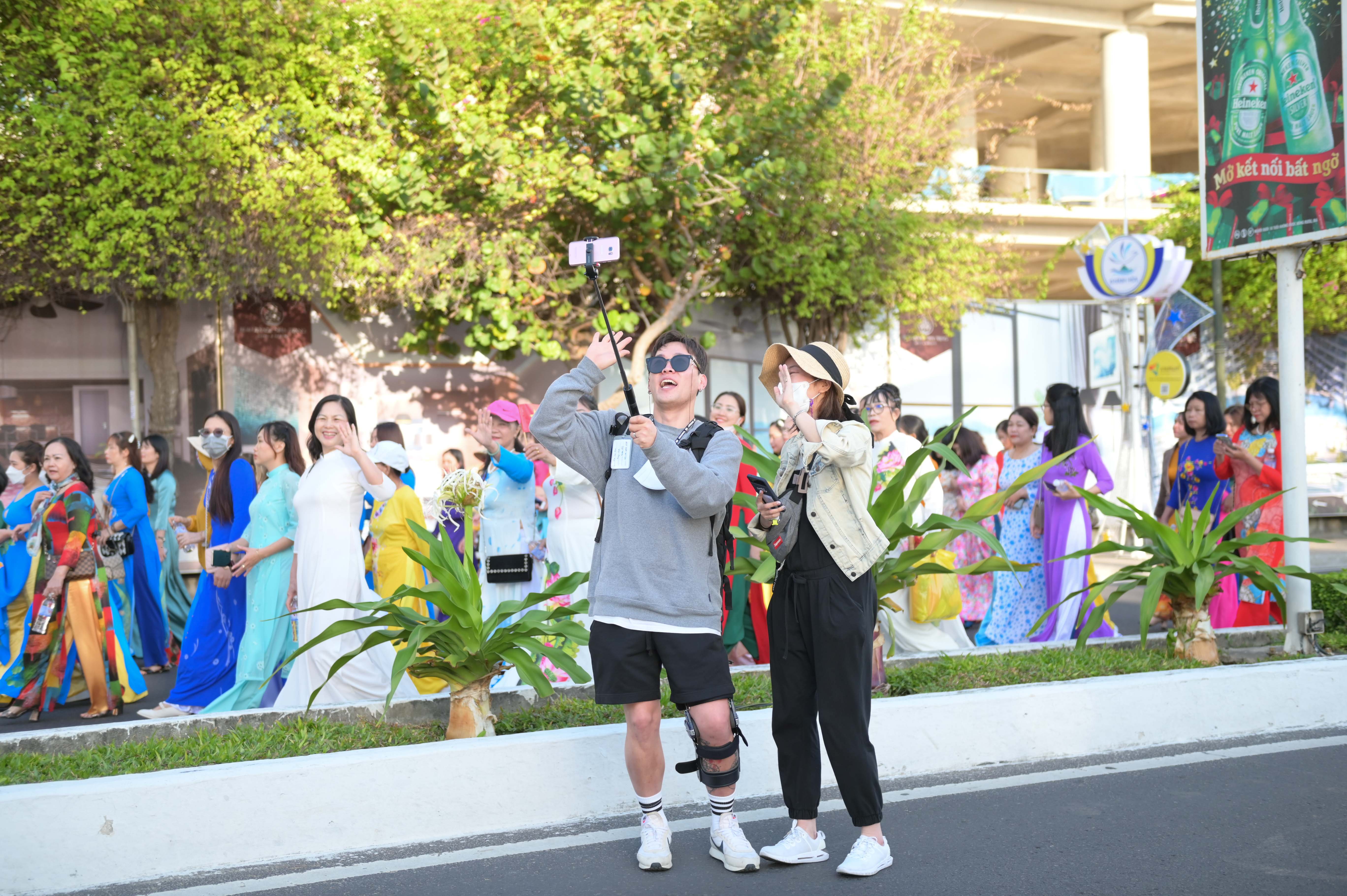 Tourists taking a selfie with marching women