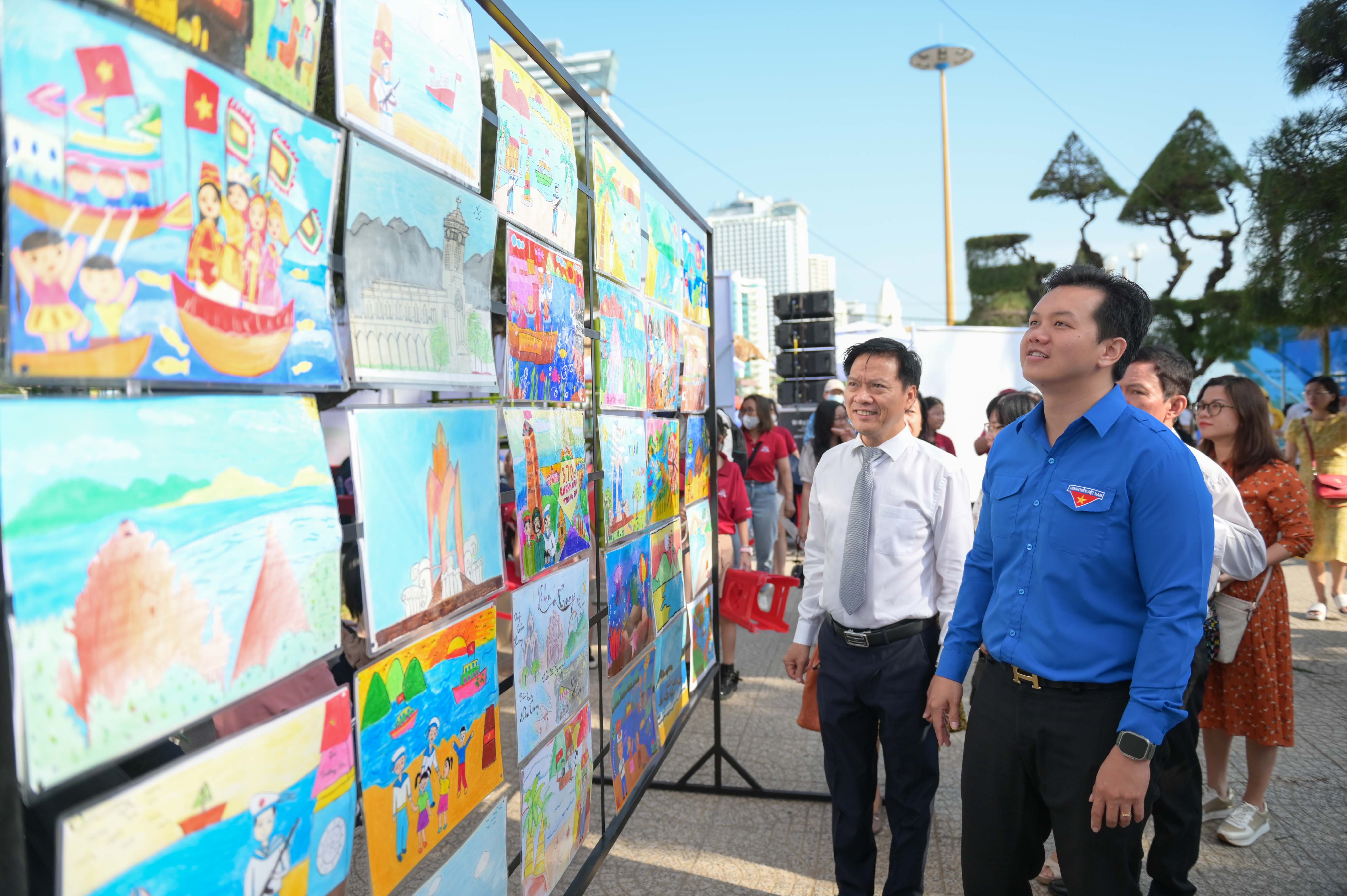 Representatives viewing displayed paintings